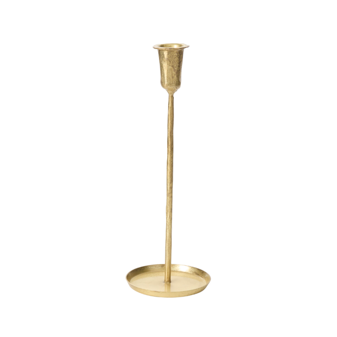 thin gold candleholder with low circular base on a white background