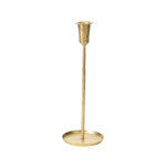 thin gold candleholder with low circular base on a white background