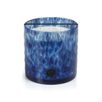 Blue glass candle with a white interior on a white background