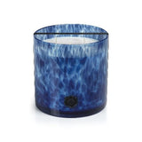 Blue glass candle with a white interior on a white background