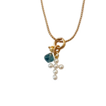  Celia Necklace features a long gold chain adorned with two thoughtful charms—a pearl cross and a blue gemstone. Wear it long for a sleek silhouette or double it up for a layered look. 
