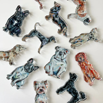 collection of acrylic dog figurines in various poses on a white background