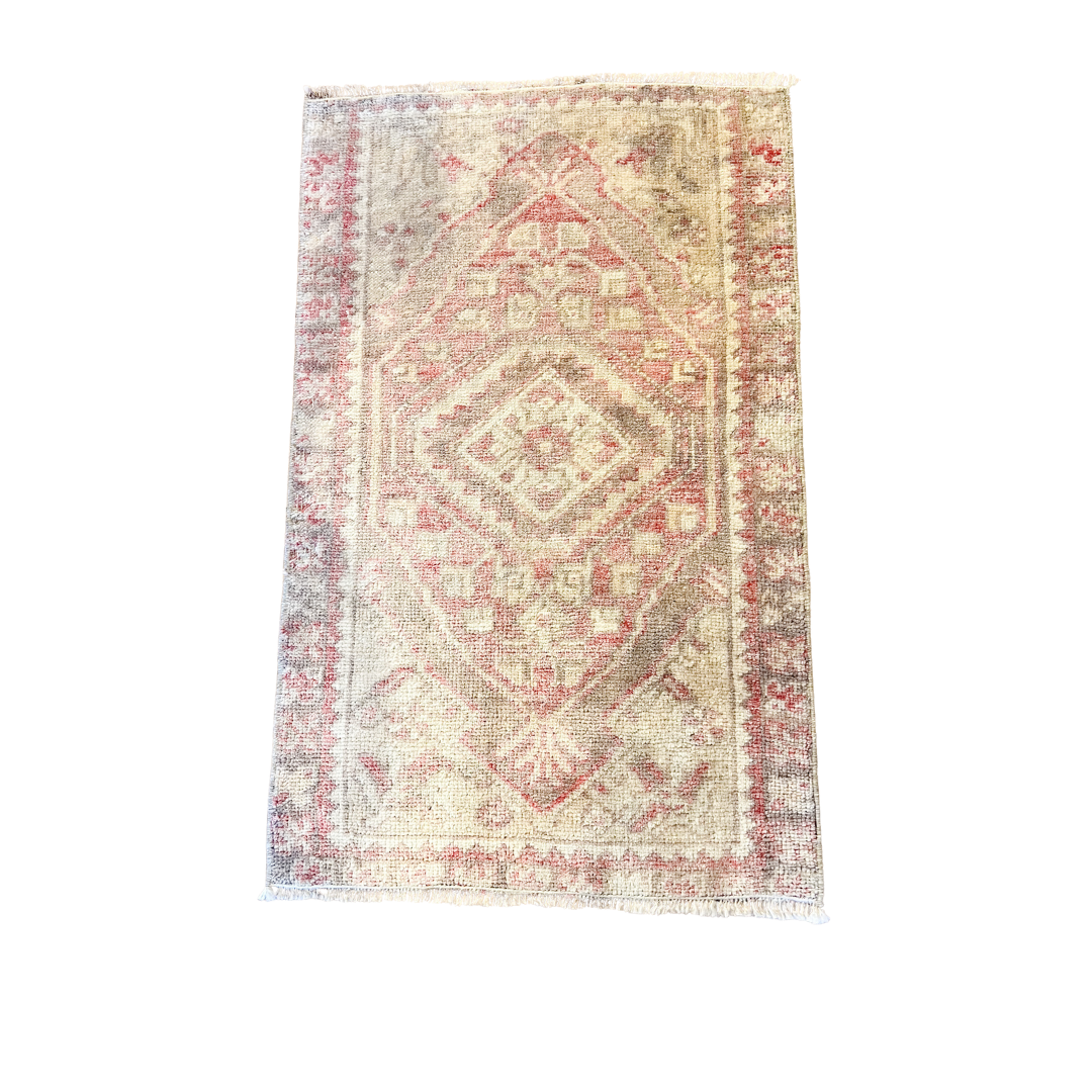 Vintage-style rug with geometric pattern on a white background