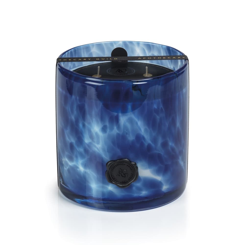 Blue marbled candle with a black lid on a white background
