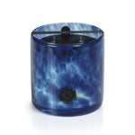 Blue marbled candle with a black lid on a white background