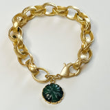 gold oval chain link bracelet with green floral pendant