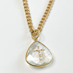 gold necklace with tear drop charm with gold and pearl cross