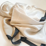 small ivory satin scarf with black trim 