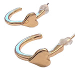 A pair of gold hoop earrings with integrated heart-shaped details and push-back closures, displayed on a white surface with a soft background.