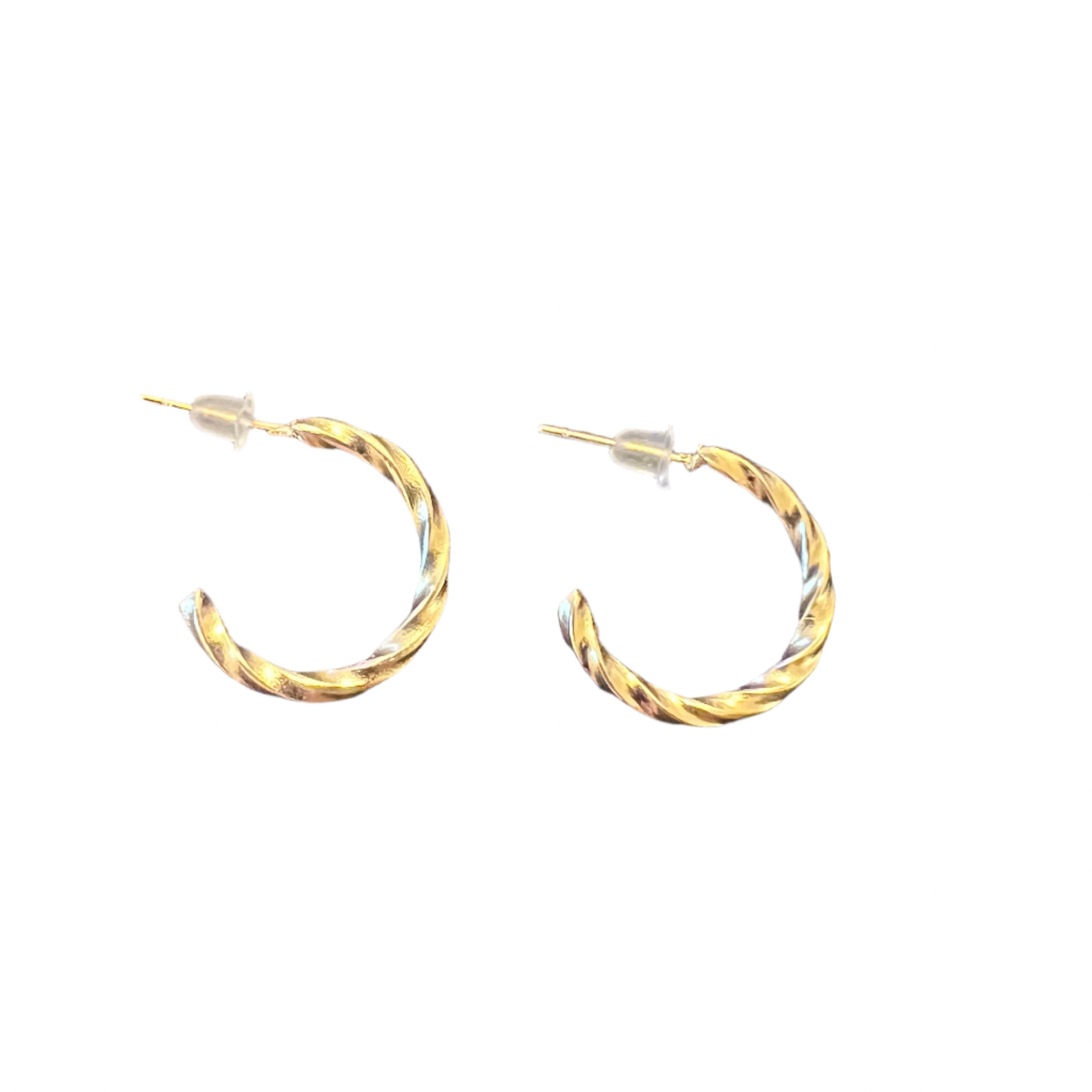 A pair of twisted gold hoop earrings with a textured design, displayed on a white background.