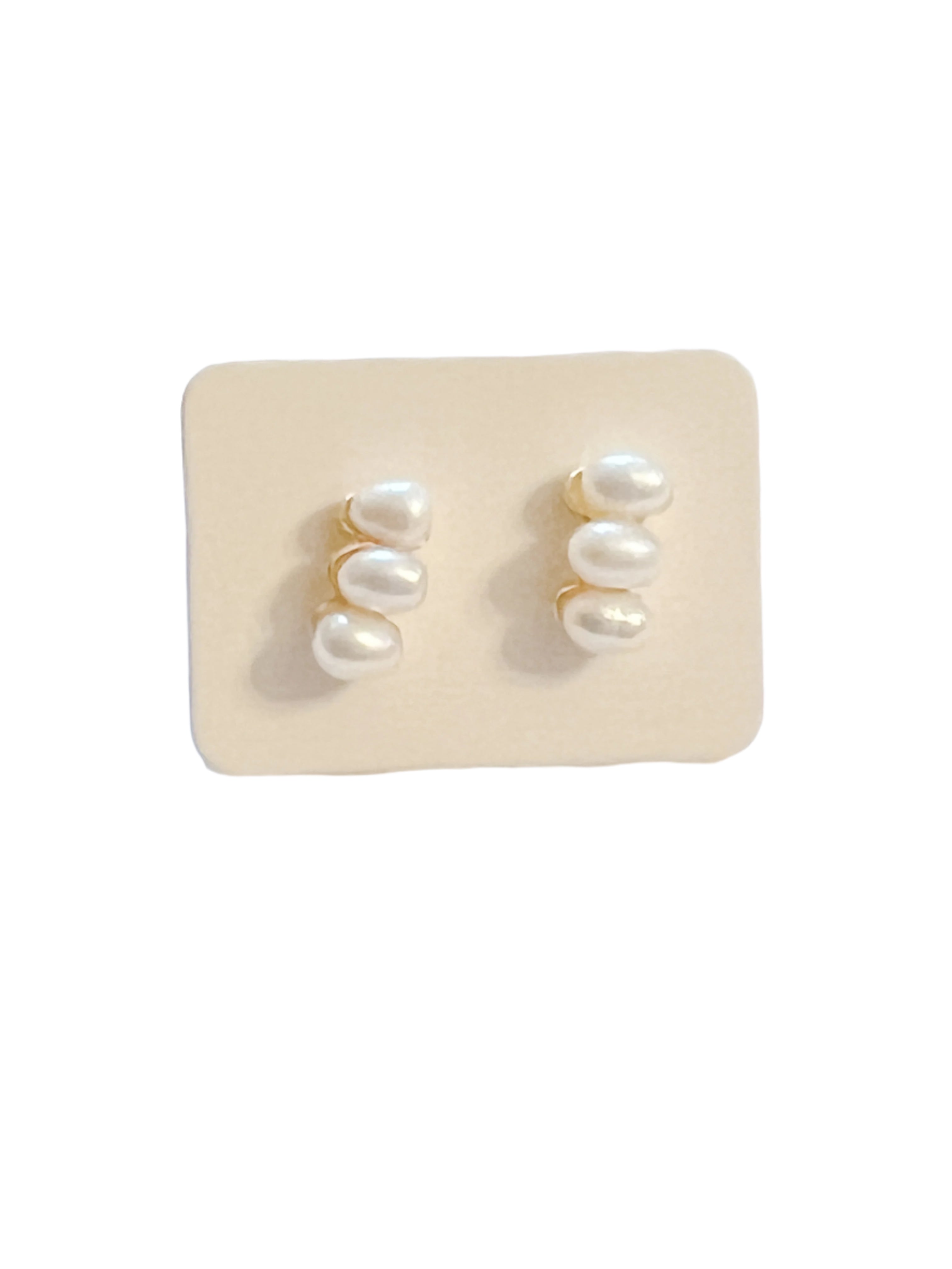 dainty earrings feature three lustrous pearls arranged in a sleek bar design,