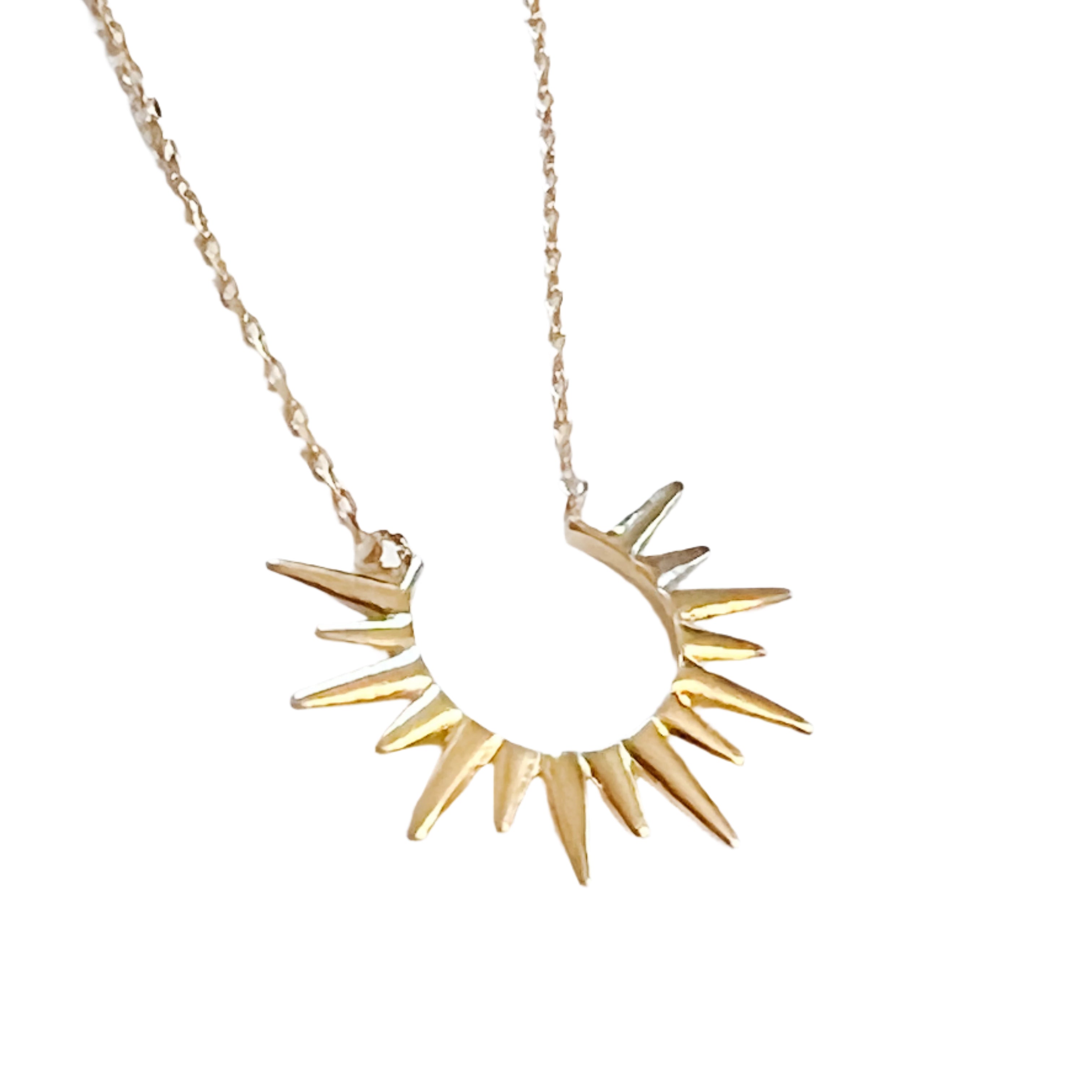 4kt gold-dipped metal, this necklace features a stunning sunburst design 