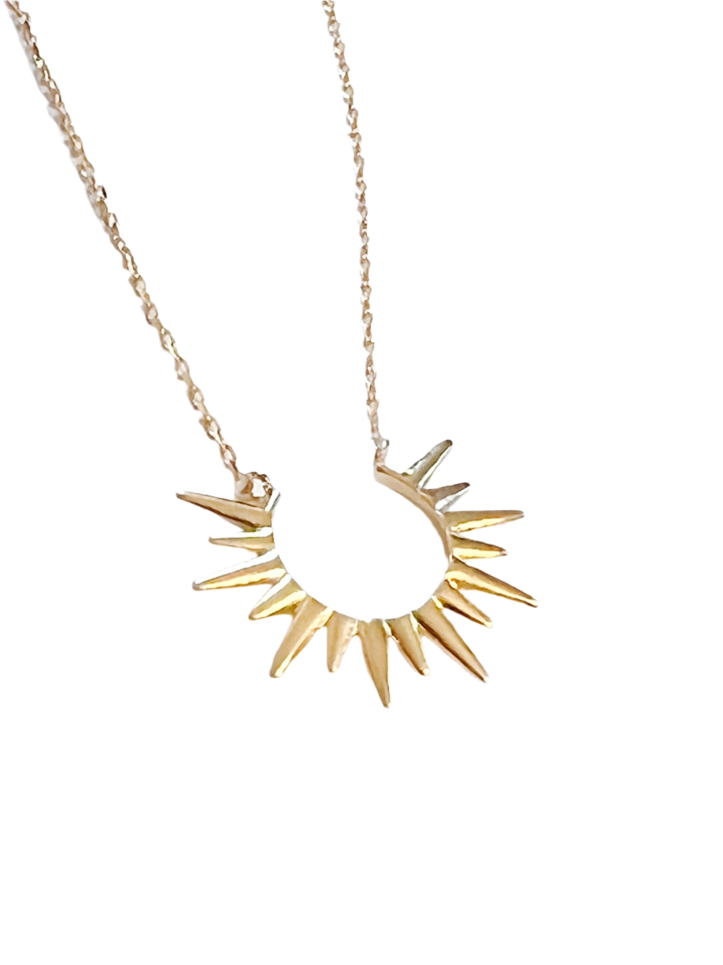 4kt gold-dipped metal, this necklace features a stunning sunburst design 