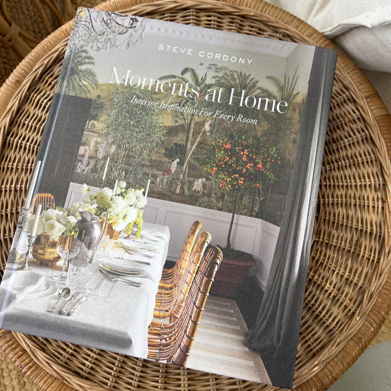 Book titled 'Moments at Home' by Steve Cordony on a woven surface