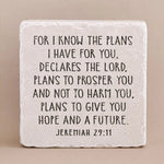 Decorative stone with engraved text from Jeremiah 29:11 on a beige background
