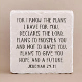 Decorative stone with engraved text from Jeremiah 29:11 on a beige background