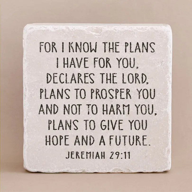 Decorative stone with engraved text from Jeremiah 29:11 on a beige background