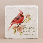 Decorative stone with engraved text from John 20:19 with a cardinal on a beige background