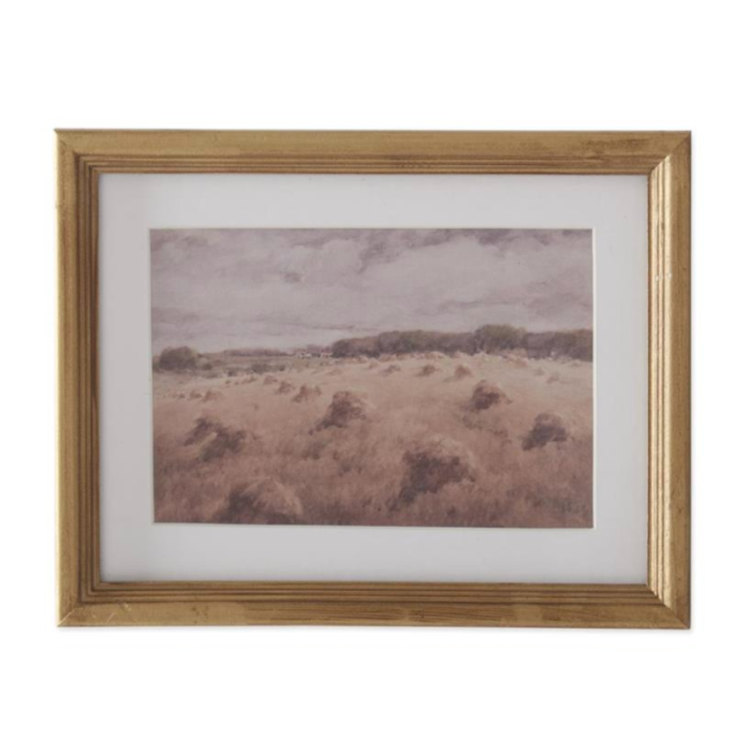 Framed landscape painting with a gold frame on a white background