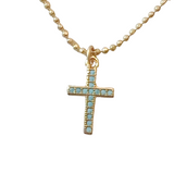  Liana Necklace features a gold beaded chain and a cross charm accented with subtle blue details. 