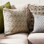 Patterned cushions on a sofa with a neutral background