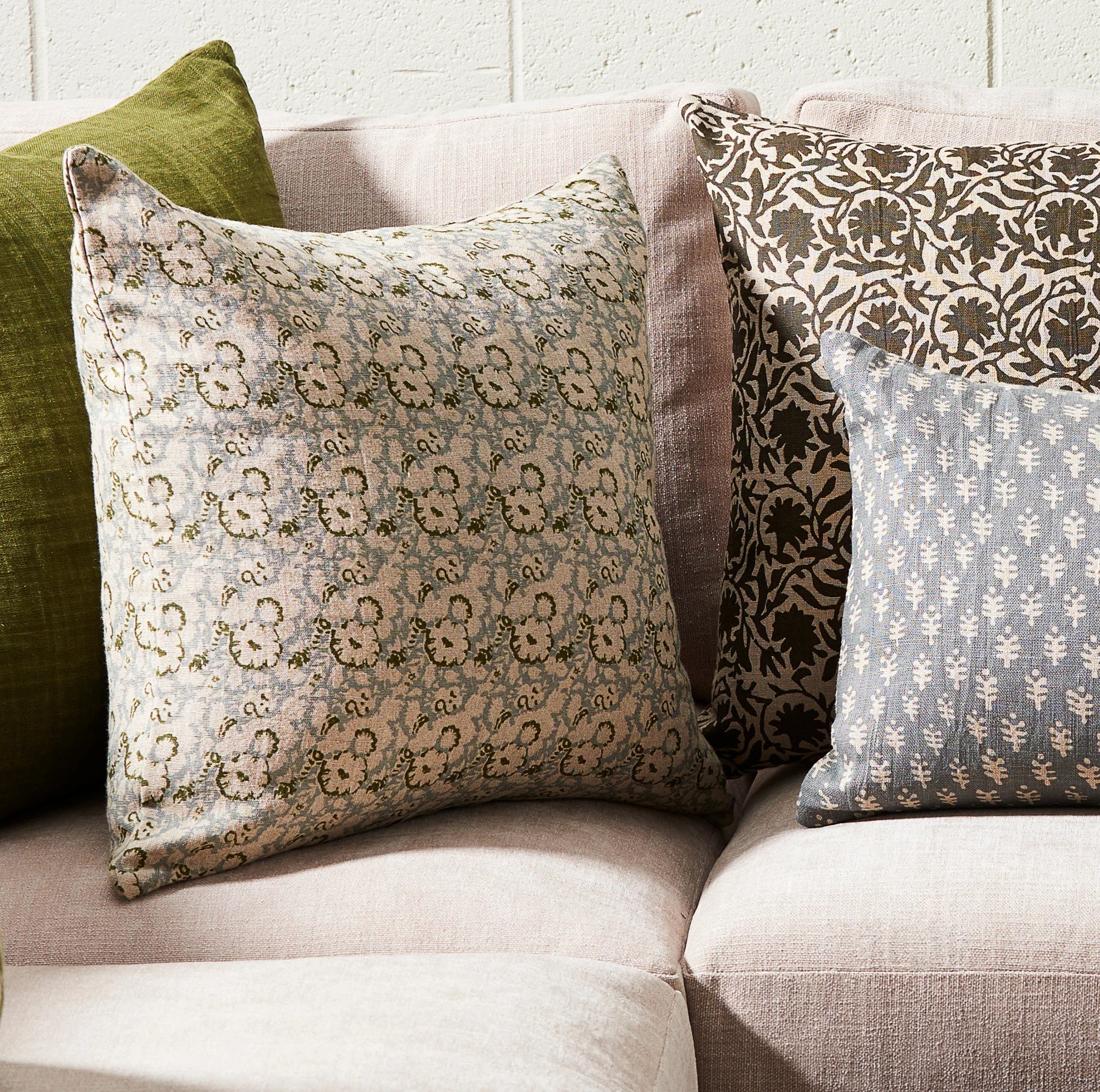 Patterned cushions on a sofa with a neutral background
