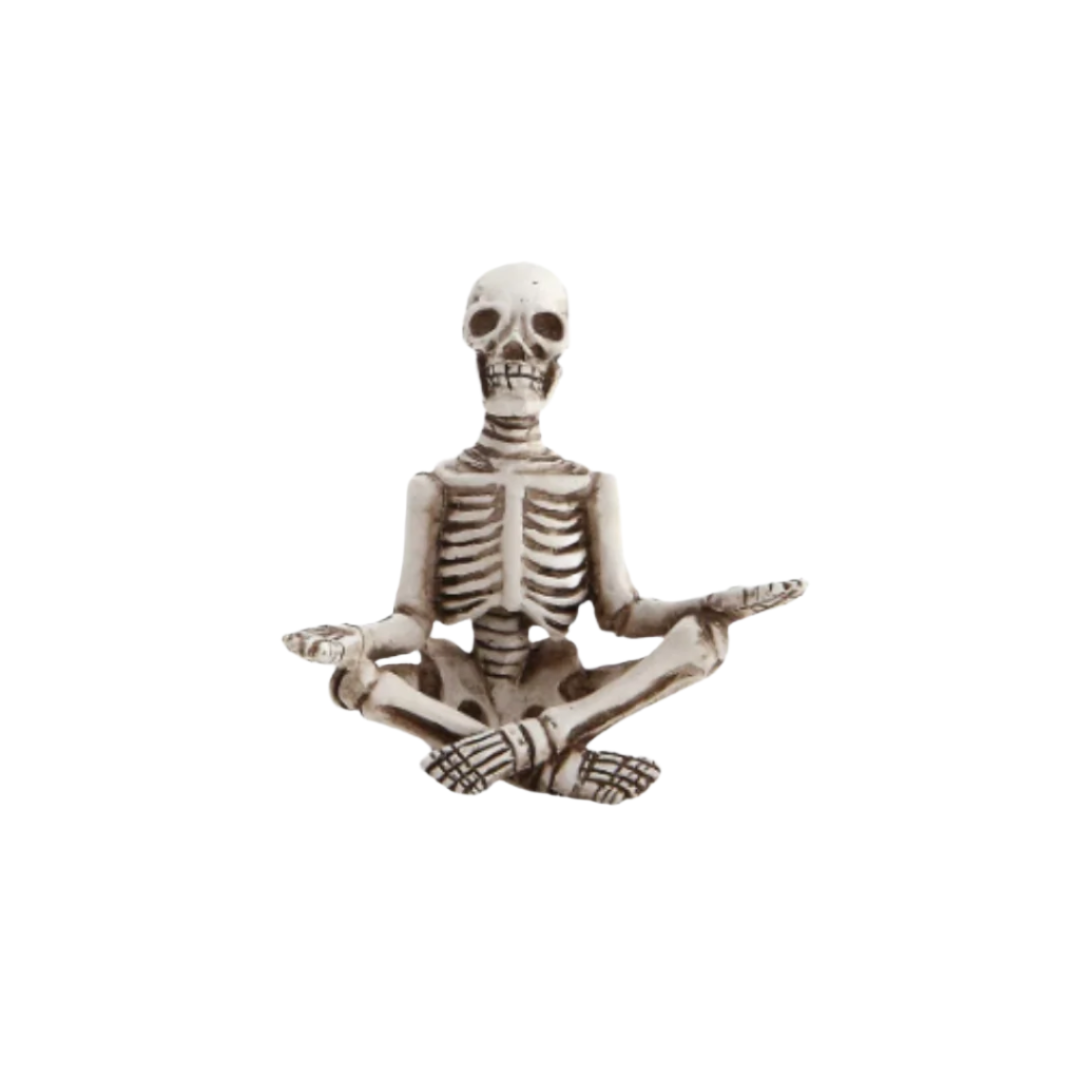 Skeletal figure in a meditative pose on a white background