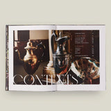 Open book showing images of decorative urns with 'CONTENTS' text.