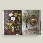 Open book with 'Spring' theme featuring floral and decorative elements on a light background