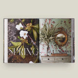 Open book with 'Spring' theme featuring floral and decorative elements on a light background