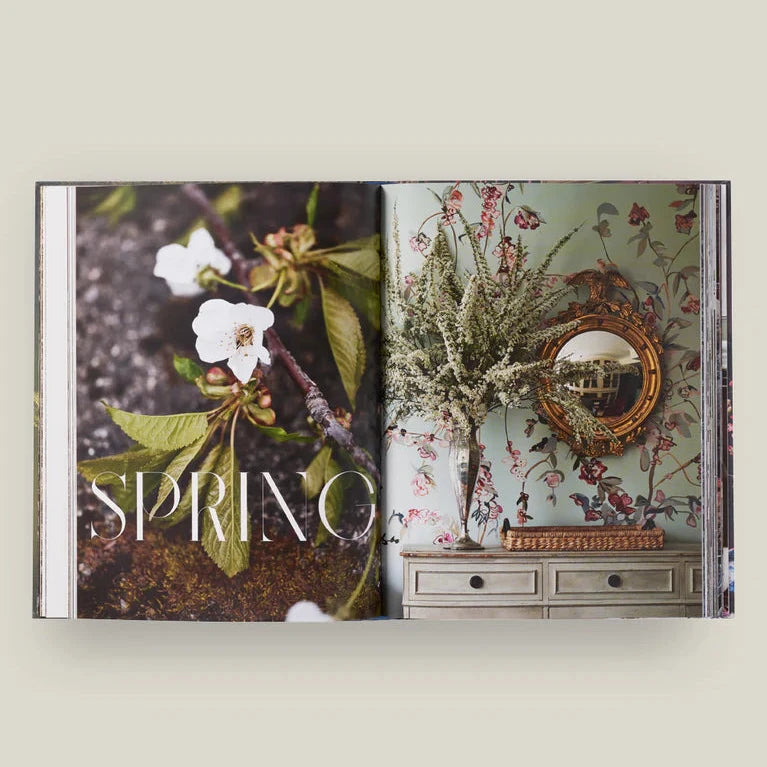 Open book with 'Spring' theme featuring floral and decorative elements on a light background