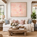 Living room with a white sofa, decorative pillows, a wooden coffee table, and abstract art on the wall.