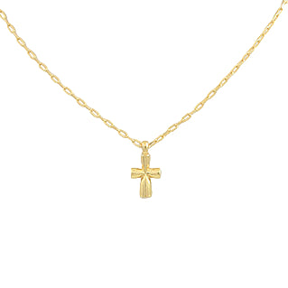 Gold necklace with a small cross pendant on a light gray background