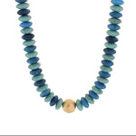 Necklace with blue beads and a gold accent on a white background