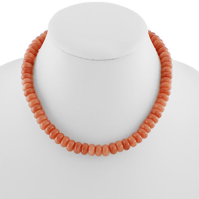 Coral beaded necklace on a mannequin with a white background