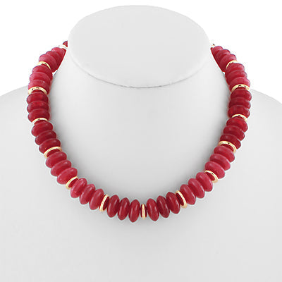 Red beaded necklace with gold accents on a mannequin against a white background