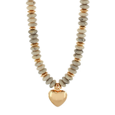 Necklace with beige beads and a gold heart pendant on a white background