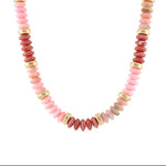 Necklace with pink and gold beads on a white background