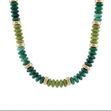 Necklace with green and gold beads on a white background