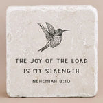 Decorative stone with engraved text from Nehemiah 8:10 and an image of a bird on a beige background