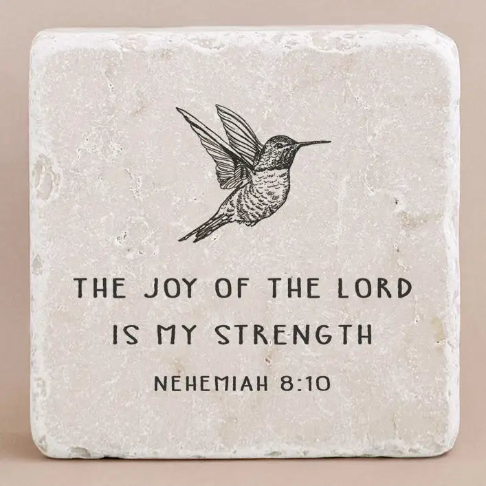 Decorative stone with engraved text from Nehemiah 8:10 and an image of a bird on a beige background