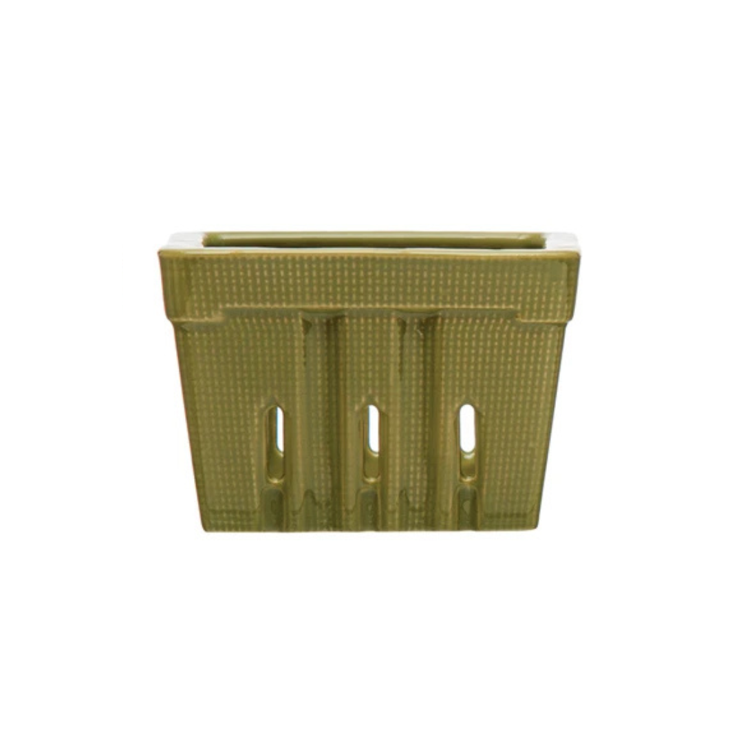 green rectangular berry basket with decorative cutouts on a white background