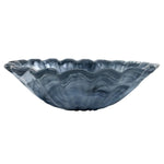 Blue glass bowl with wavy edge on a white background