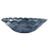 Blue glass bowl with wavy edge on a white background