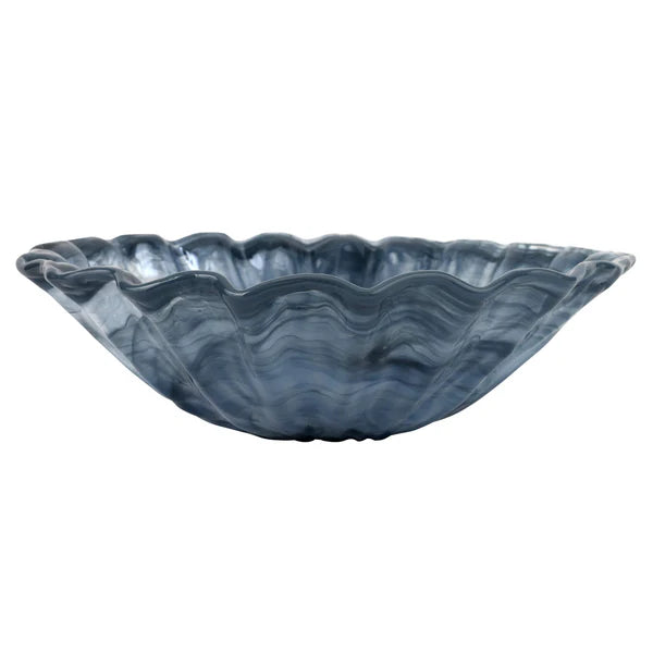 Blue glass bowl with wavy edge on a white background