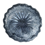 A round, scalloped-edge glass bowl with a textured, sunburst radial pattern in smoky gray and translucent blue tones, shown from a top-down perspective on a white background.