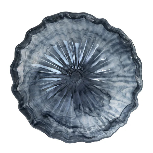 A round, scalloped-edge glass bowl with a textured, sunburst radial pattern in smoky gray and translucent blue tones, shown from a top-down perspective on a white background.