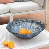 Blue marbled bowl with oranges on a white table