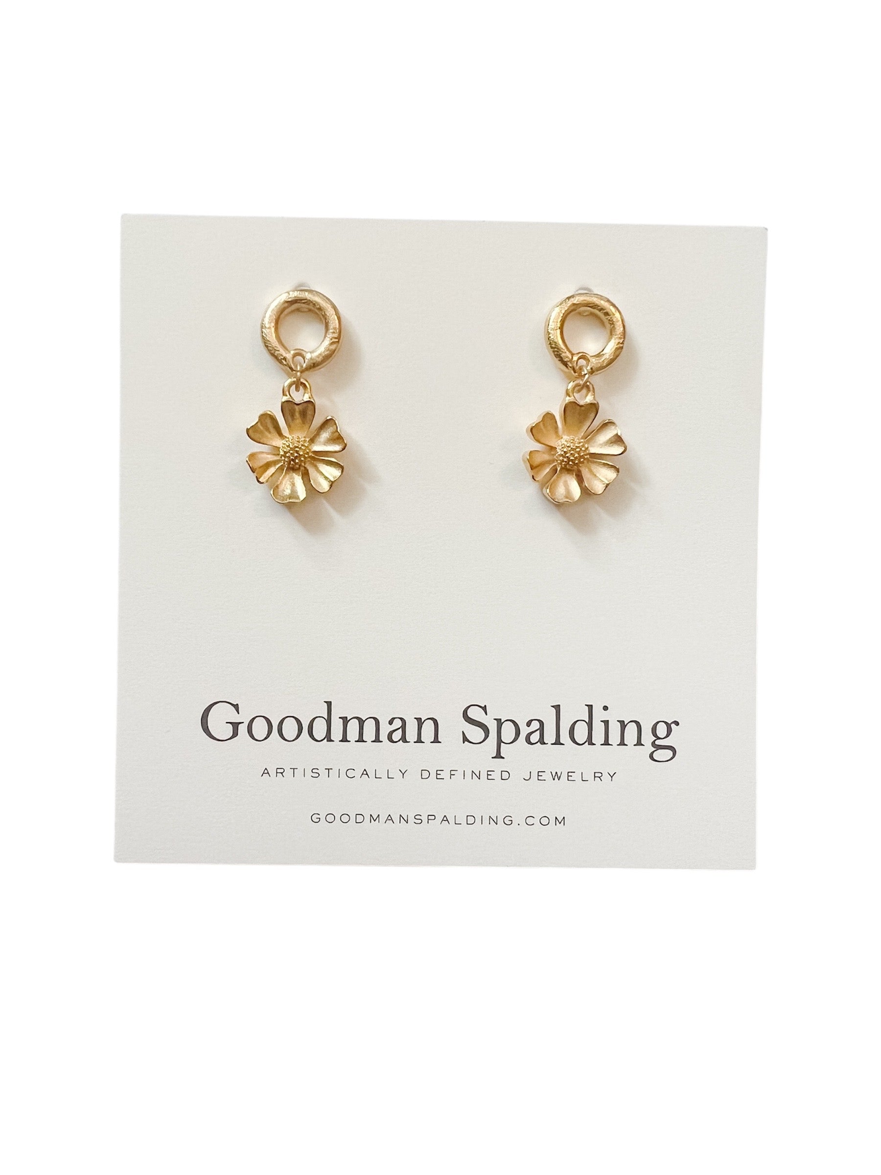 gold flower charms suspended from classic circular studs.
