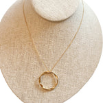 dainty gold chain necklace with large gold twisting open circle pendant
